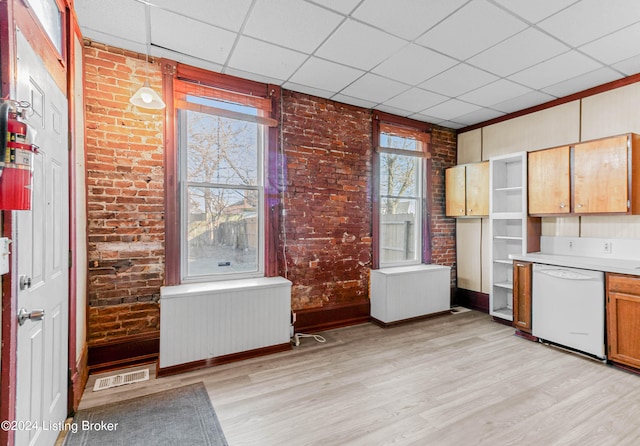 kitchen featuring white dishwasher, a paneled ceiling, radiator, and light wood-type flooring