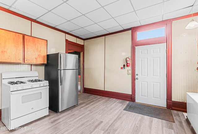 kitchen featuring a paneled ceiling, white range with gas cooktop, light hardwood / wood-style floors, and stainless steel fridge