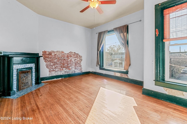 unfurnished living room with light hardwood / wood-style floors and ceiling fan