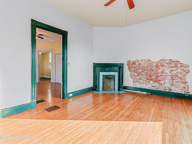 unfurnished living room with light hardwood / wood-style floors and ceiling fan