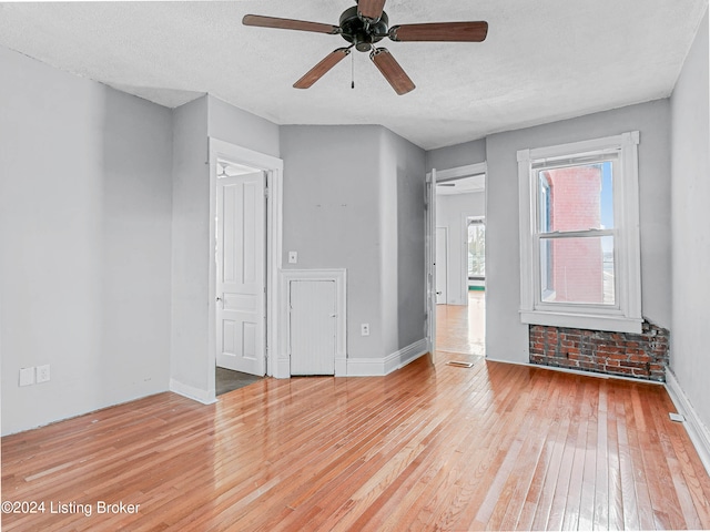 empty room featuring ceiling fan and light wood-type flooring