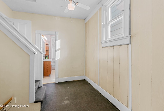 interior space with ceiling fan