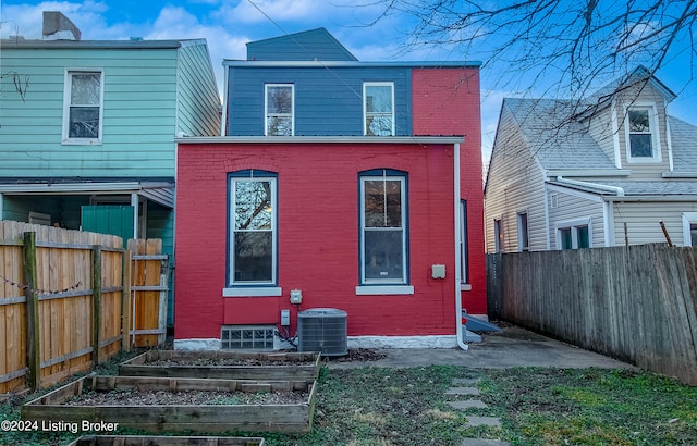 back of house featuring central AC