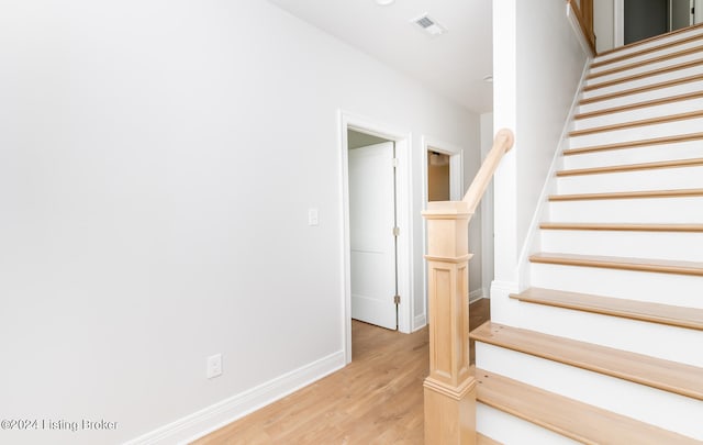 staircase featuring light hardwood / wood-style flooring