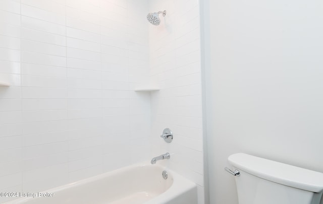 bathroom featuring tiled shower / bath combo and toilet