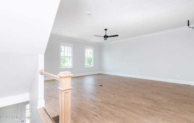 empty room featuring ceiling fan, light hardwood / wood-style flooring, and ornamental molding