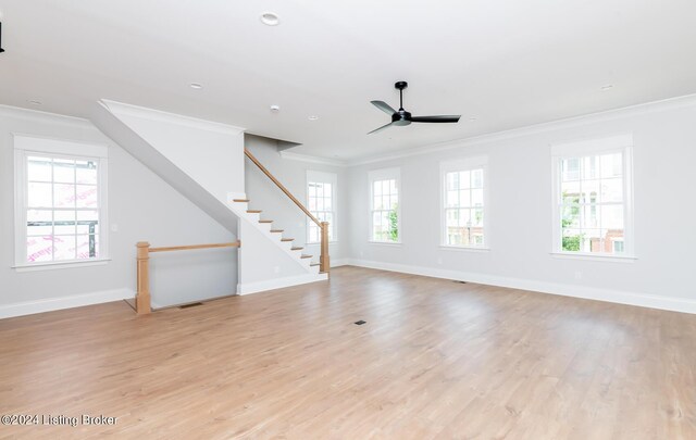 unfurnished living room with light hardwood / wood-style floors, crown molding, a wealth of natural light, and ceiling fan