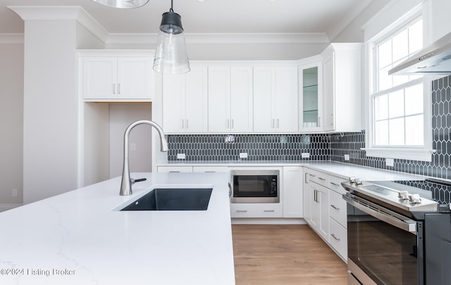 kitchen featuring plenty of natural light, hanging light fixtures, stainless steel electric range, and black microwave