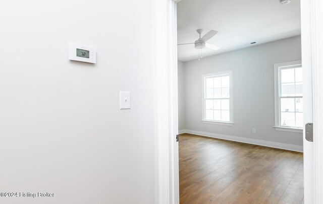 interior space featuring ceiling fan, hardwood / wood-style flooring, and a healthy amount of sunlight