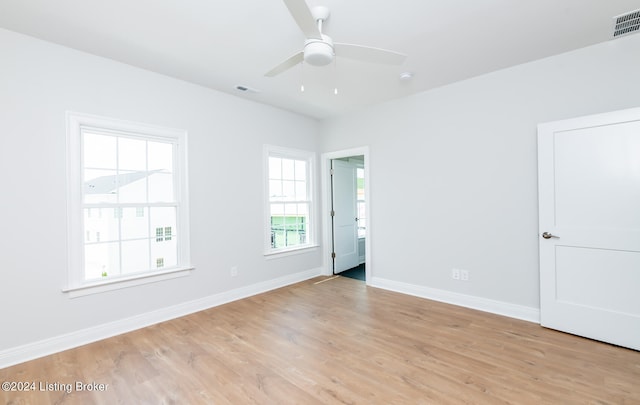 spare room with light wood-type flooring and ceiling fan