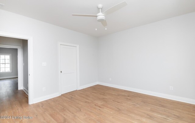 spare room featuring light hardwood / wood-style flooring and ceiling fan