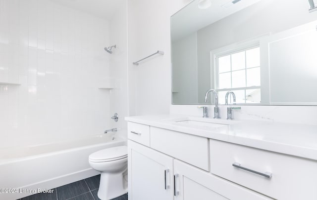 full bathroom featuring tile patterned flooring, toilet, vanity, and tiled shower / bath