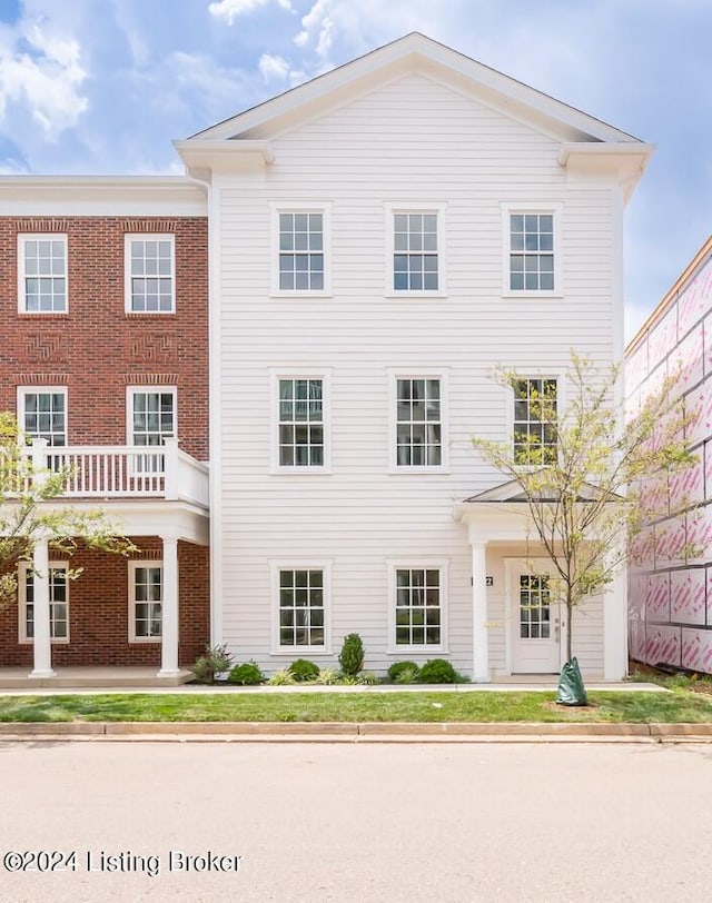 view of front of house featuring a balcony