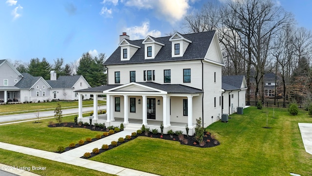 view of front facade featuring a porch, a front yard, and central air condition unit