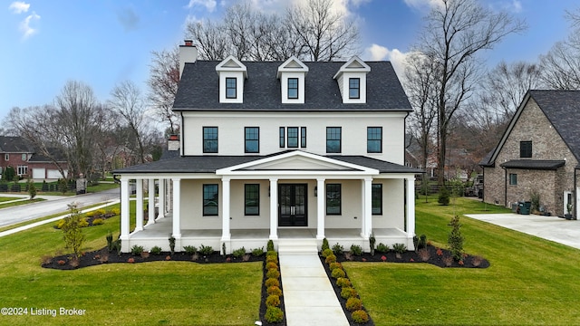 view of front of house with a front yard and a porch