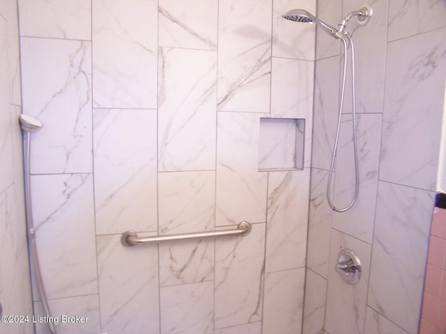 bathroom with a tile shower