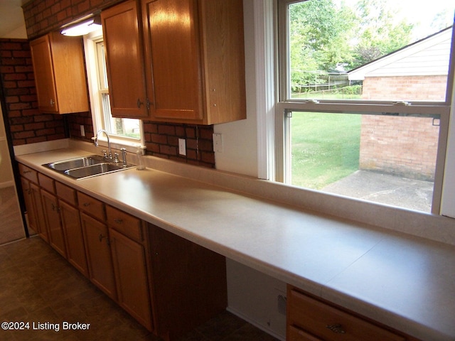 kitchen featuring decorative backsplash, sink, and a wealth of natural light