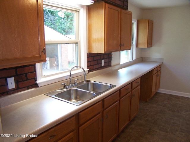 kitchen featuring tasteful backsplash and sink