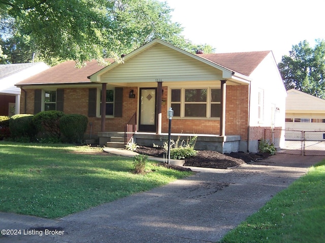 view of front facade with covered porch and a front yard