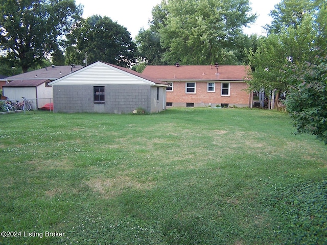 back of property featuring a yard