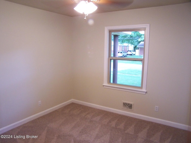 unfurnished room with ceiling fan and carpet floors