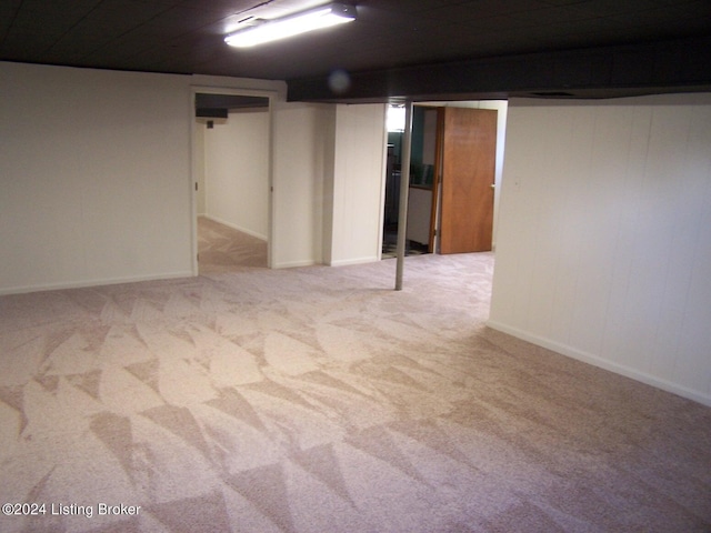 basement featuring light carpet