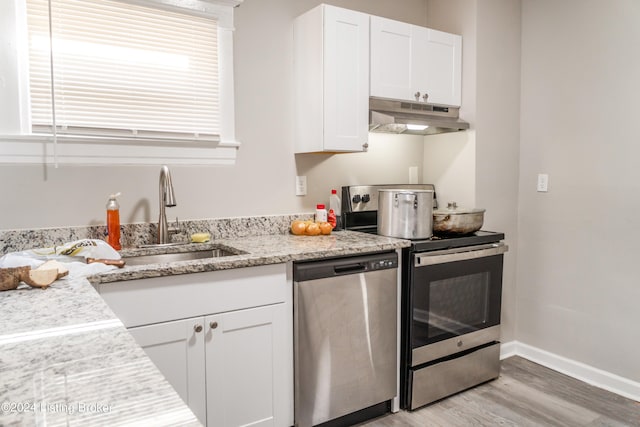 kitchen featuring light hardwood / wood-style floors, range, white cabinetry, and dishwasher