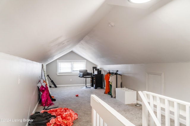 bedroom with lofted ceiling and light colored carpet