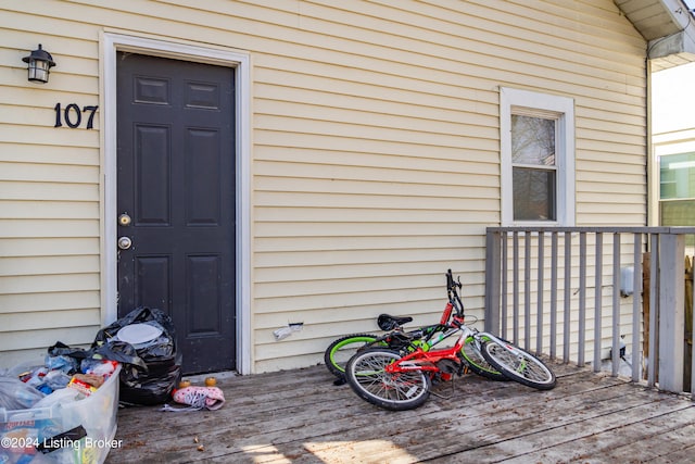 view of exterior entry featuring a wooden deck