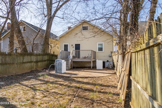 rear view of house featuring a wooden deck