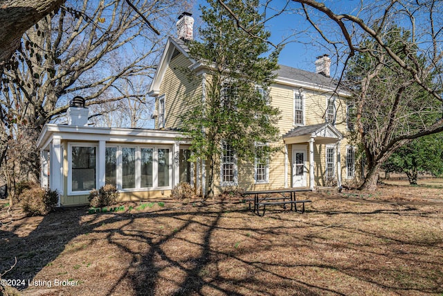 view of front of home with a sunroom