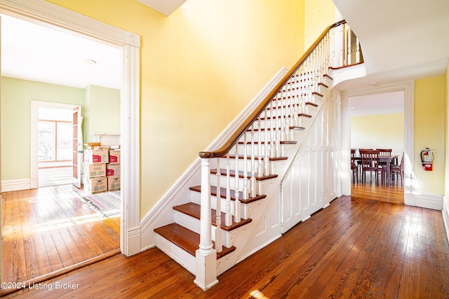 staircase with dark wood-type flooring