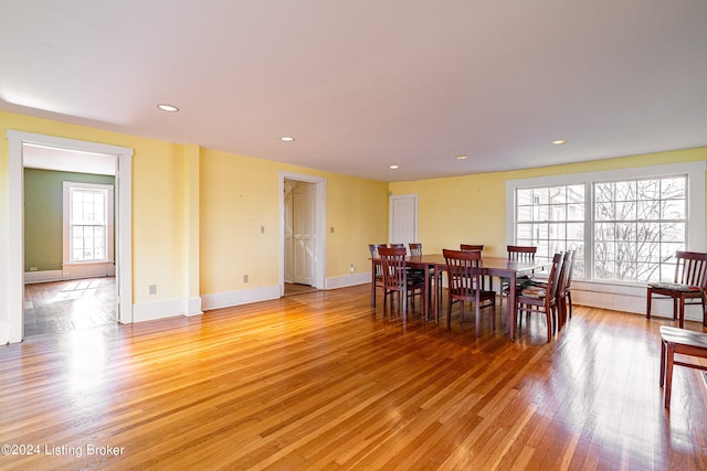 dining space with light hardwood / wood-style flooring and a healthy amount of sunlight