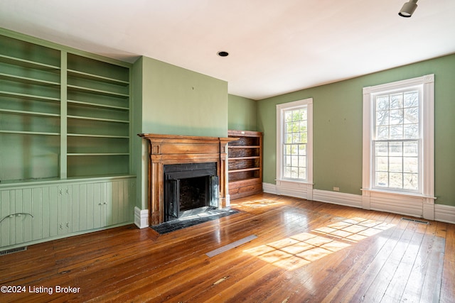 unfurnished living room with dark hardwood / wood-style flooring