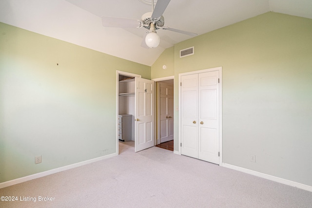 unfurnished bedroom with ceiling fan, light carpet, and vaulted ceiling