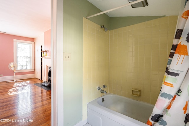 bathroom featuring shower / tub combo with curtain and hardwood / wood-style flooring