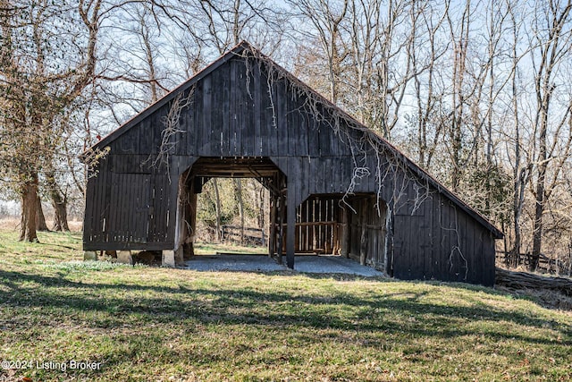 surrounding community with an outdoor structure and a yard