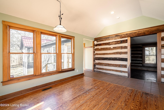 unfurnished room with dark hardwood / wood-style flooring, a healthy amount of sunlight, and lofted ceiling