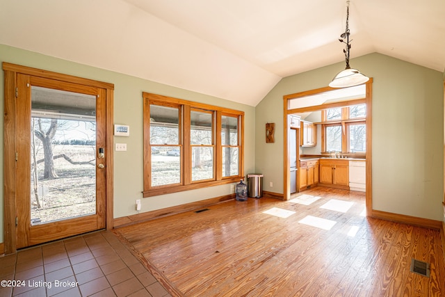 interior space featuring sink and vaulted ceiling