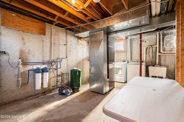 basement with washing machine and clothes dryer and sink