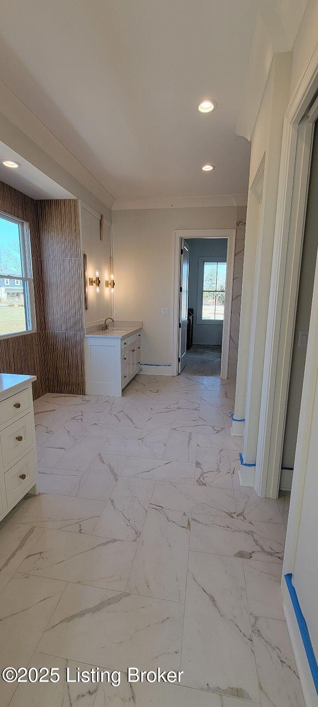 hallway featuring marble finish floor, a wealth of natural light, and recessed lighting