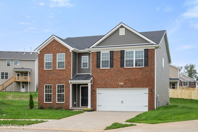 view of front of home featuring a garage and a front lawn