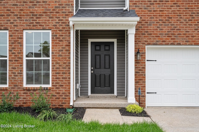 view of exterior entry with a garage