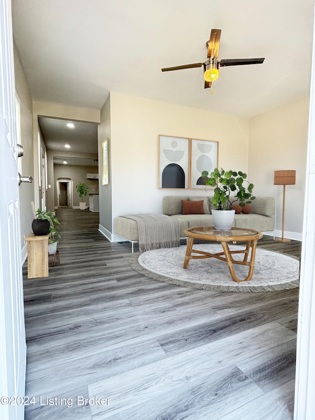 living room featuring hardwood / wood-style flooring and ceiling fan