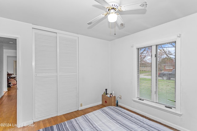 unfurnished bedroom featuring a closet, ceiling fan, and light wood-type flooring