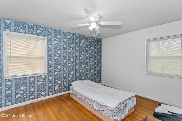 bedroom with ceiling fan and hardwood / wood-style flooring