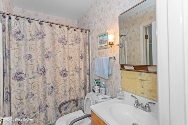 bathroom featuring oversized vanity and toilet