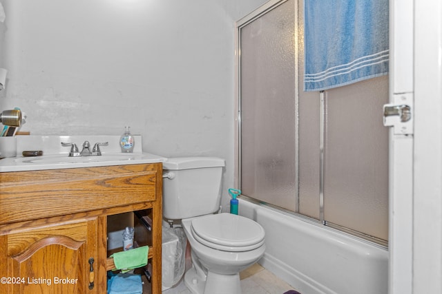 full bathroom featuring tile floors, toilet, enclosed tub / shower combo, and vanity