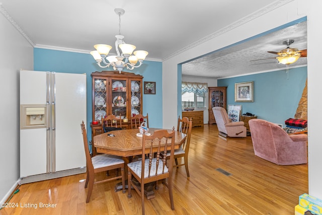 dining room featuring ornamental molding, a textured ceiling, ceiling fan with notable chandelier, and light hardwood / wood-style flooring