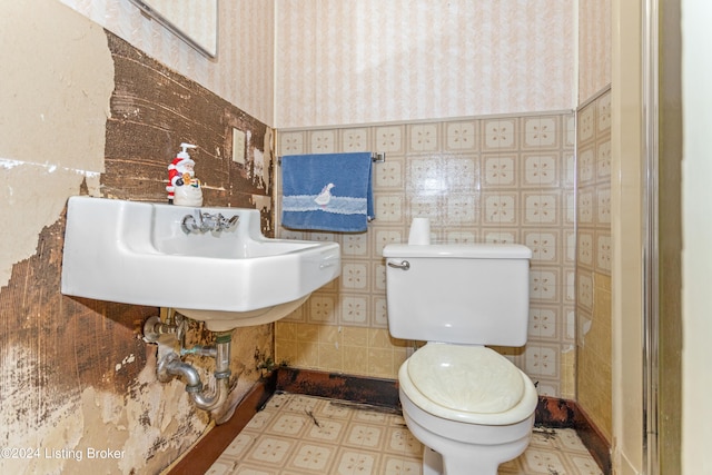 bathroom featuring toilet and tile floors